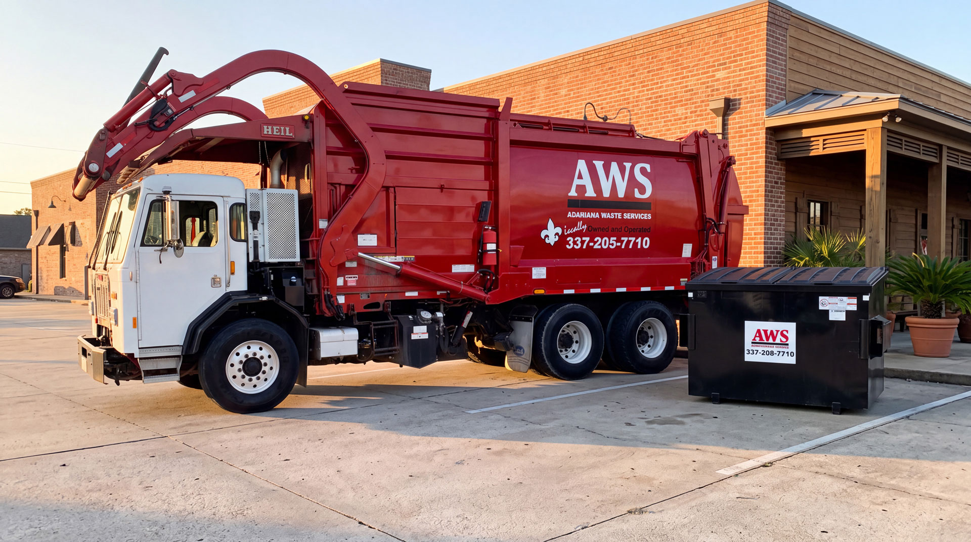 Acadiana Waste Services front-load commercial garbage truck servicing a dumpster outside a Louisiana business.